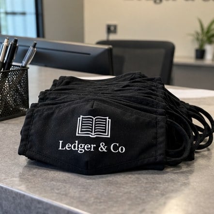 Custom company staff face masks on a reception desk