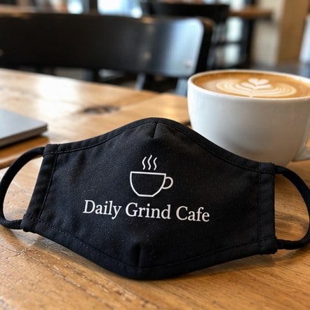 Custom face mask on a cafe table