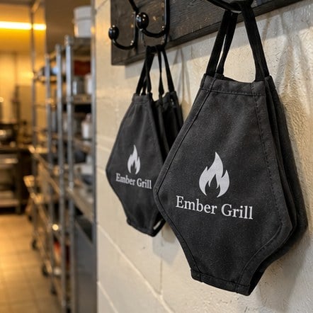 Custom restaurant staff face masks on hooks