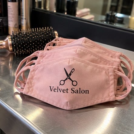 Custom salon face masks on a station counter