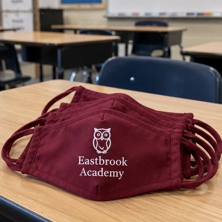 Custom school face masks on classroom desks